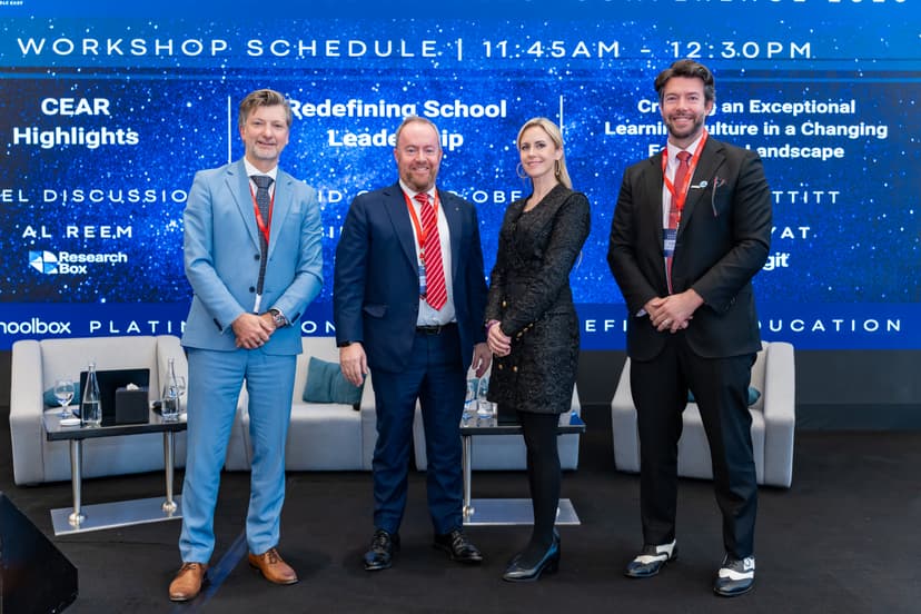 Alex with fellow speakers at an education conference