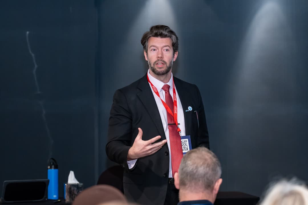 Alex speaking at a conference