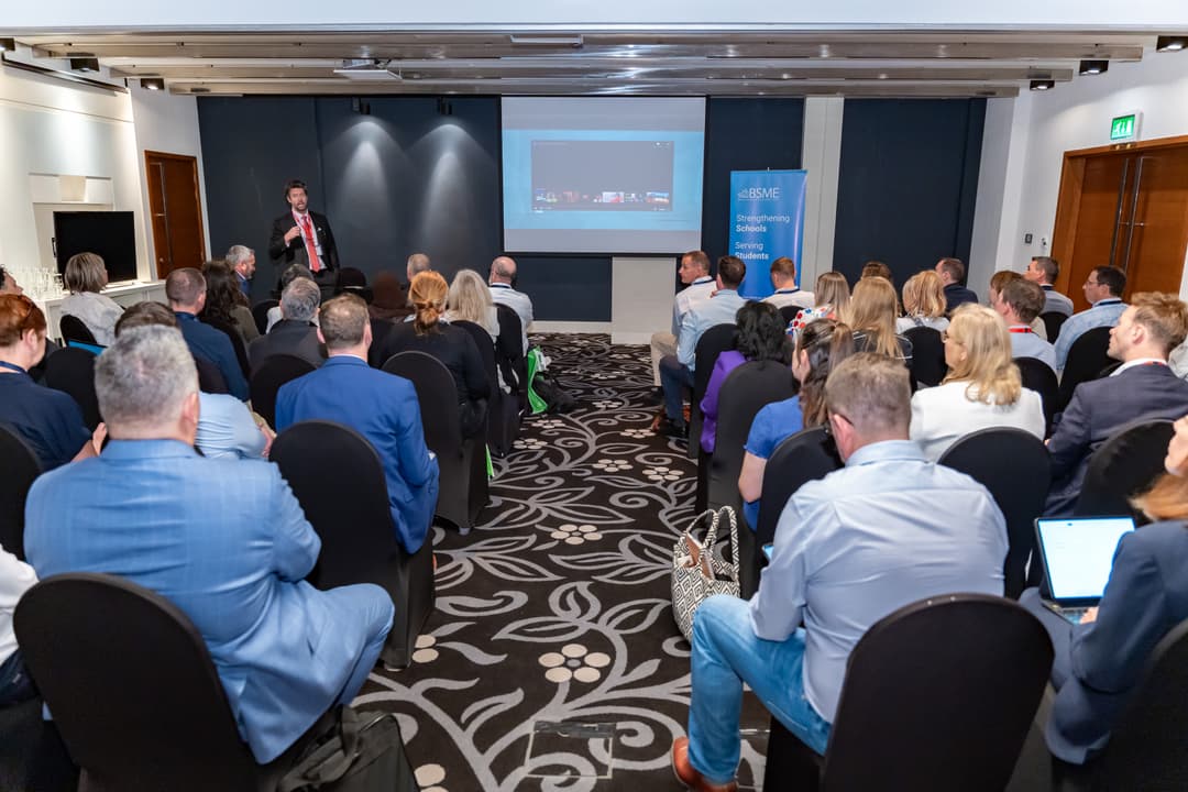 Full conference room during Alex's presentation